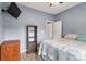 Well-lit bedroom featuring a mounted TV, shelving, and cozy bedding for ultimate relaxation at 3820 Leela Palace Way, Fort Mill, SC 29708