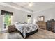Comfortable bedroom showcasing natural light from two windows, hardwood floors, and classic furniture at 3820 Leela Palace Way, Fort Mill, SC 29708