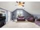 Spacious upstairs bonus room with angled ceilings, comfortable seating, and natural light at 3820 Leela Palace Way, Fort Mill, SC 29708