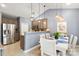 Bright dining area featuring modern pendant lights, a dining table, and stainless steel refrigerator at 3820 Leela Palace Way, Fort Mill, SC 29708