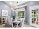 Charming dining room with ample seating, elegant lighting, and outdoor views through a window at 3820 Leela Palace Way, Fort Mill, SC 29708