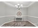 Formal dining room showcases updated light fixture, light gray paint, and elegant trimwork at 3820 Leela Palace Way, Fort Mill, SC 29708