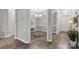Open-concept home with elegant trimwork and wood floors connects to the dining room and entryway at 3820 Leela Palace Way, Fort Mill, SC 29708