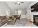 Open-concept living area features wood floors, a fireplace, and neutral paint, with views into the entryway and dining room at 3820 Leela Palace Way, Fort Mill, SC 29708