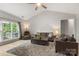 Bright living room featuring a vaulted ceiling, fan, and ample seating with a view of the backyard at 3820 Leela Palace Way, Fort Mill, SC 29708