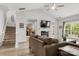 Cozy living room with fireplace, hardwood floors, and backyard access, offering seamless indoor-outdoor living at 3820 Leela Palace Way, Fort Mill, SC 29708