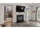 Inviting living room features a fireplace with TV, hardwood floors, and view of open spaces at 3820 Leela Palace Way, Fort Mill, SC 29708
