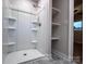 Bathroom area featuring a shower with built-in shelves and storage alongside a linen closet and a window at 404 Kings Dr # 7, Cherryville, NC 28021