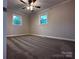 Bedroom featuring new carpet, neutral walls, and bright windows that offers comfort and relaxation at 404 Kings Dr # 7, Cherryville, NC 28021