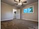 Bedroom with ceiling fan and plush carpet, showcasing a bright window, and a convenient closet for storage at 404 Kings Dr # 7, Cherryville, NC 28021