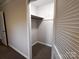 An interior closet showcasing a functional layout with an upper shelf and carpeted flooring at 404 Kings Dr # 7, Cherryville, NC 28021
