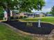Charming brick home featuring a well-manicured lawn, fresh mulch, and lush landscaping at 404 Kings Dr # 7, Cherryville, NC 28021