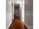 Hallway with hardwood floors and white trim, leading to various rooms in the home at 404 Kings Dr # 7, Cherryville, NC 28021