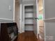 Hallway closet with built-in shelving, adjacent to a vintage heater and nearby rooms at 404 Kings Dr # 7, Cherryville, NC 28021