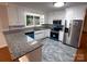 Bright kitchen with granite countertops, stainless steel appliances, and ample cabinet space at 404 Kings Dr # 7, Cherryville, NC 28021