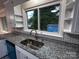 Close-up of kitchen featuring granite countertops, stylish backsplash, and stainless steel sink at 404 Kings Dr # 7, Cherryville, NC 28021