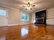 Cozy living room features a brick fireplace, built-in shelving, and hardwood floors at 404 Kings Dr # 7, Cherryville, NC 28021