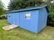 Exterior of a charming blue outbuilding with double doors and concrete ramp in yard at 404 Kings Dr # 7, Cherryville, NC 28021