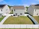 Aerial view of fenced backyard with lawn, patio area, and well maintained landscaping at 446 Misty Law Ln, Clover, SC 29710