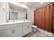 Bright bathroom featuring double sinks, white cabinets, and a large framed mirror at 446 Misty Law Ln, Clover, SC 29710