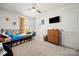 Bright bedroom with a ceiling fan, a twin sized bed, tv and drawers at 446 Misty Law Ln, Clover, SC 29710