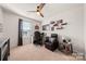 Bright bedroom featuring neutral carpet, ceiling fan, home office setup, and comfortable recliner at 446 Misty Law Ln, Clover, SC 29710
