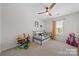 Bright bedroom with neutral carpet, ceiling fan, window, and play area at 446 Misty Law Ln, Clover, SC 29710
