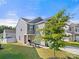 Well-manicured lawn surrounds a charming two-story home with neutral siding and a two-car garage at 446 Misty Law Ln, Clover, SC 29710