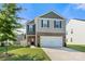 Charming two-story home featuring a two-car garage, well-maintained lawn, and inviting curb appeal at 446 Misty Law Ln, Clover, SC 29710