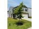 Inviting two-story home with a well-kept lawn, tree, and charming architectural details at 446 Misty Law Ln, Clover, SC 29710