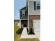 Stylish two-story home with a welcoming porch, brick accents, and manicured landscaping at 446 Misty Law Ln, Clover, SC 29710