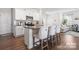Bright kitchen featuring a kitchen island with bar seating, stainless appliances and adjacent living area at 446 Misty Law Ln, Clover, SC 29710