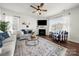 Cozy living room featuring hardwood floors, a fireplace, and bright natural lighting at 446 Misty Law Ln, Clover, SC 29710