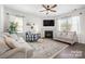 Bright living room features a fireplace, ceiling fan, and comfortable seating arrangements at 446 Misty Law Ln, Clover, SC 29710