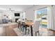 Bright living area featuring dining table, fireplace, and sliding glass doors to the backyard at 446 Misty Law Ln, Clover, SC 29710