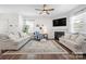 Bright living room features a fireplace, ceiling fan, and comfortable seating at 446 Misty Law Ln, Clover, SC 29710