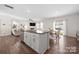 Open-concept living space with island, kitchen, dining, and living area at 446 Misty Law Ln, Clover, SC 29710