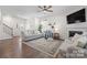 Open-concept living room with a fireplace, ceiling fan, and hardwood floors at 446 Misty Law Ln, Clover, SC 29710