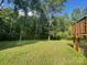 Lush, grassy backyard with mature trees and a deck at 517 Grassy Creek Run, Chester, SC 29706