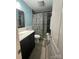 Well-lit bathroom features neutral colors, a white vanity and a floral shower curtain at 517 Grassy Creek Run, Chester, SC 29706