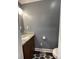 Small bathroom features grey walls, wood cabinet, and toilet at 517 Grassy Creek Run, Chester, SC 29706