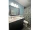 Bright bathroom with white vanity, large mirror, and a shower/tub combo with decorative curtain at 517 Grassy Creek Run, Chester, SC 29706
