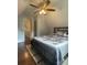 A cozy bedroom with a ceiling fan and hardwood floors, adjacent to a hallway for easy access at 517 Grassy Creek Run, Chester, SC 29706