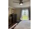 Bright bedroom featuring a ceiling fan, dresser, window seat, and natural light streaming through decorative curtains at 517 Grassy Creek Run, Chester, SC 29706