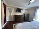 Cozy bedroom with hardwood floors, ceiling fan, dresser, TV, and white coverlet on a king-sized bed at 517 Grassy Creek Run, Chester, SC 29706