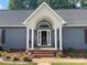 The house features a front entry with a brick landing and a covered portico with white columns at 517 Grassy Creek Run, Chester, SC 29706