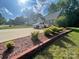 Well-maintained front yard with brick-lined mulch bed and ample parking on long driveway at 517 Grassy Creek Run, Chester, SC 29706