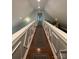 A hallway with wood floors, paneled walls, overhead lighting, and a door leading to additional space at 517 Grassy Creek Run, Chester, SC 29706
