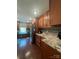 A well-lit kitchen features wood cabinets, mosaic backsplash, stainless steel appliances and hardwood floors at 517 Grassy Creek Run, Chester, SC 29706