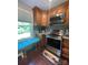 Bright kitchen nook with built-in seating, stainless appliances, wood cabinets, and hardwood floors at 517 Grassy Creek Run, Chester, SC 29706